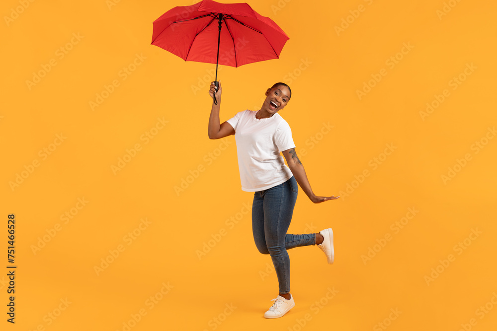 black lady holding a red umbrella poses standing in studio black lady holding a red umbrella poses standing in studio
