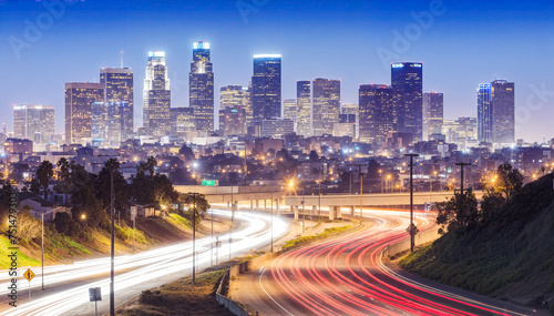 A stunning view of the Los Angeles skyline at night  with freeway in the foreground.