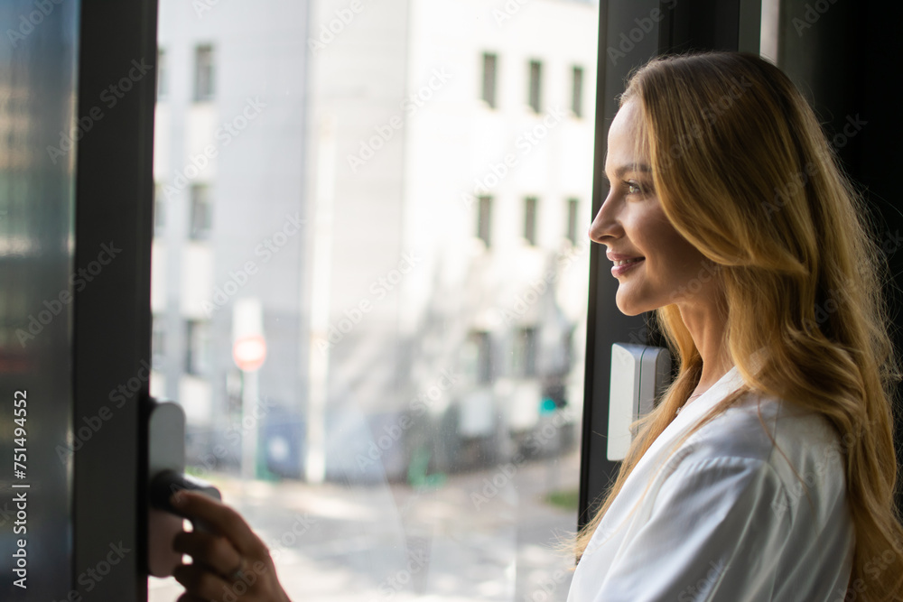 Young woman gazing out of a window
