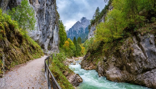 hollental gorge also known as devil s gorge or hell valley gorge in bavaria near garmisch partenkirchen town a tiny trail is winding at the foot of tremendous rocks and a rumbling river photo