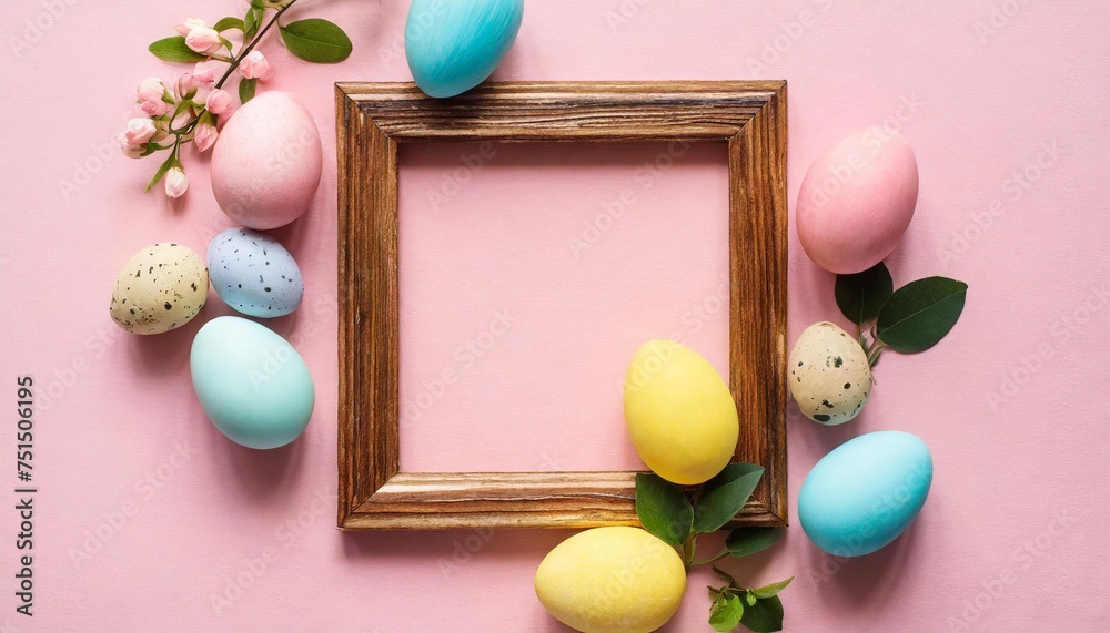 easter eggs and wooden frame on pink background