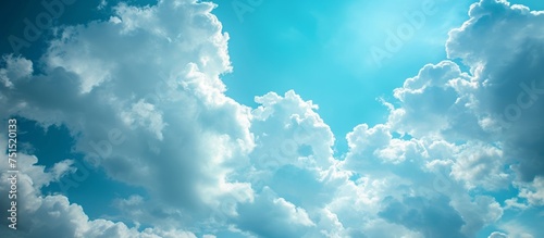 Serene panoramic view of the vast blue sky filled with fluffy white clouds on a sunny day