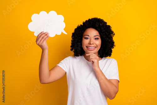 Photo of intelligent woman with perming coiffure dressed white t-shirt hold mind bubble finger on chin isolated on yellow color background