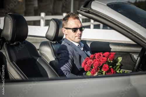 Elegant Man with Red Roses Awaiting His Date