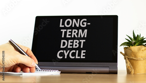 Long-term debt cycle symbol. Concept words Long-term debt cycle on beautiful black tablet. Beautiful white background. Businessman hand. Calculator. Business Long-term debt cycle concept. Copy space. photo