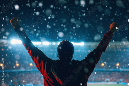 Winter celebration Person standing with raised arms in snowy stadium setting, feeling triumphant and energized by the cold