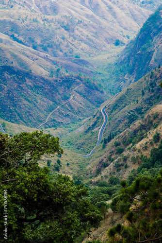 Obraz na płótnie Beautiful curvy Road on the mountains of Lansdowne, Uttarakhand. Aerial view of amazing curved road through the mountains. w salonie