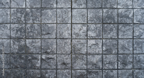 Black paving stones. Paving surface road. Texture made of big gray tile top view  © Alex