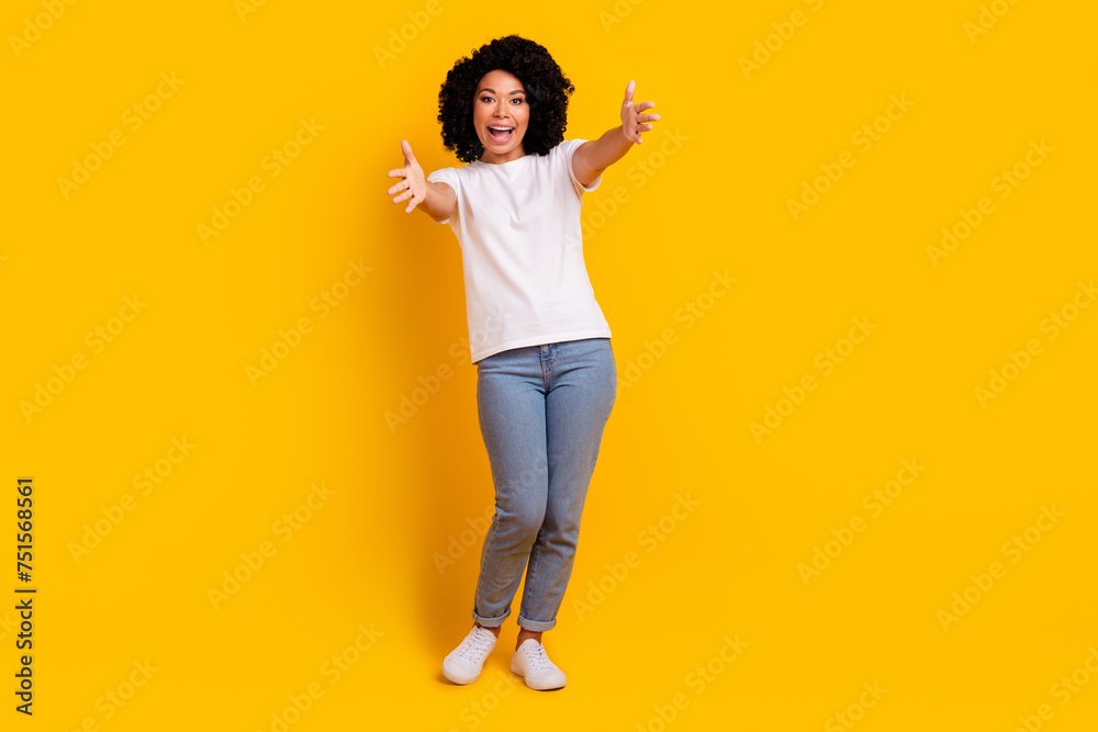 Full length photo of cheerful friendly lady dressed white t-shirt open arms ready hug you isolated yellow color background Full length photo of cheerful friendly lady dressed white t-shirt open arms ready hug you isolated yellow color background
