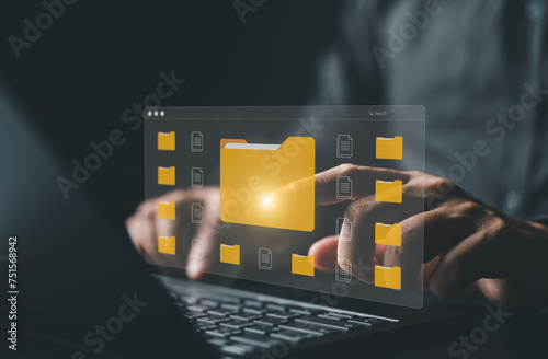 Document management. Man uses a tablet to manage enterprise file content management, digital asset handling, document sharing, categorization, workflow, and backup data software for efficient storing. photo