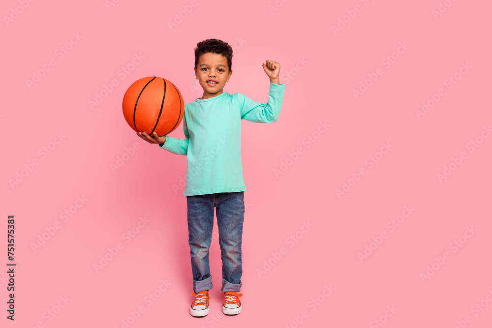 Full size photo of charming small boy hold basketball ball raise fist wear trendy aquamarine outfit isolated on pink color background - obrazy, fototapety, plakaty 
