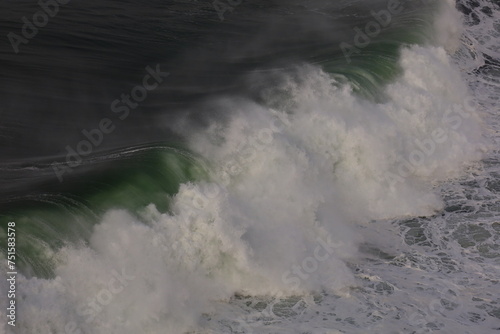 View on a wave on the Northern beach located in Nazaré in the Oeste region, in the historical province of Estremadura, Portugal