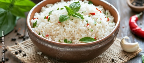 Aromatic rice dish with fresh basil leaves and black pepper in a rustic bowl