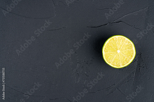 Juicy half of a lime fruit on a dark background