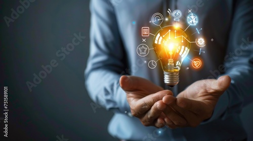 Businessman holding creative light bulb with growth graph and aerospace icons.