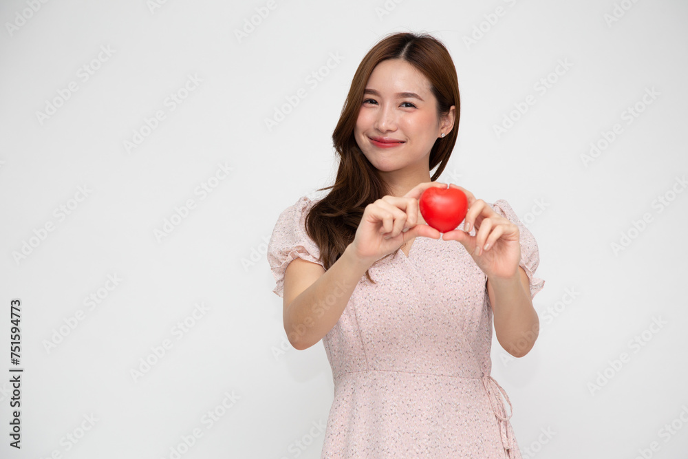 Young Asian woman holding red love heart sign isolated on white background Young Asian woman holding red love heart sign isolated on white background
