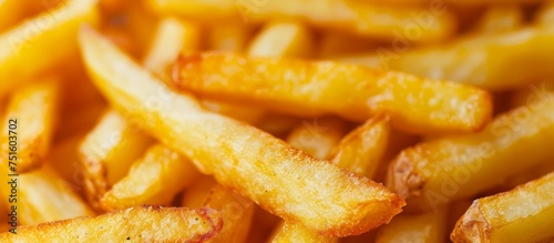 Delicious pile of golden crispy French fries in a heap on a plate