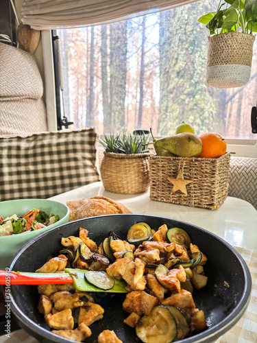 Interior of camper van motorhome with food on the table and gorest view outside the window. Concept of vanlife and travel people vacation lifestyle photo