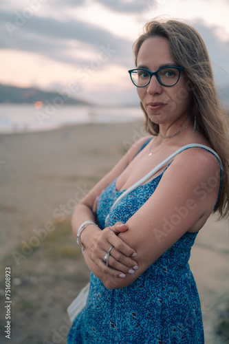 Woman sits on the beach and...