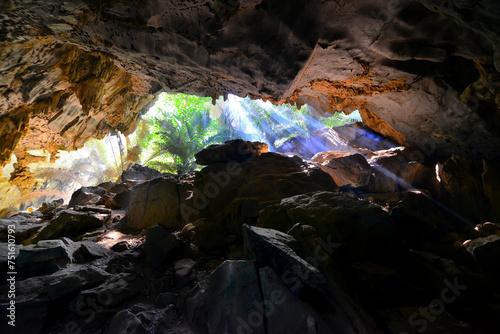 Wide angle shot of the sun rays over "Hup pa tat" a large limestone cave with its ancient forest such as walking into dinosaur era.This is an unique nature tourist attraction in Thailand.. 