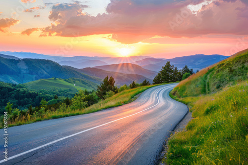 Mountain road at colorful sunset in summer.