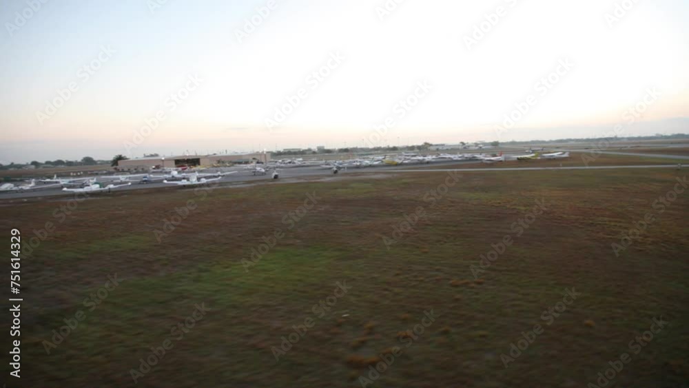 Flying over empty field and airport at dusk Flying over empty field and airport at dusk
