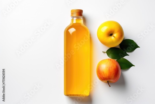 Bottle of fresh apple juice and apple on a white background isolated top view