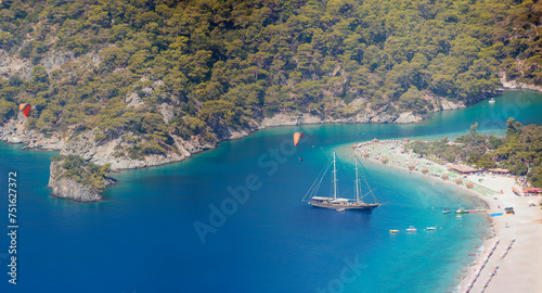 Fototapeta Naklejka Na Ścianę i Meble -  Blue gulet anchored at the Aegean sea - Panoramic view of Oludeniz Beach And Blue Lagoon, Oludeniz beach is best beaches in Turkey - Fethiye, Turkey