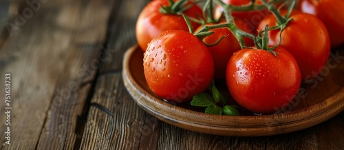 Fresh ripe organic tomatoes in a rustic wooden bowl on a natural wooden table