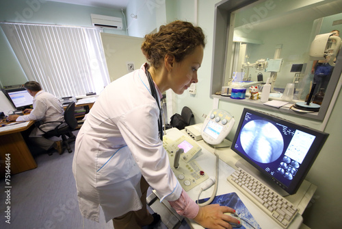 The doctor looks at x-rays of the lungs on a computer screen photo
