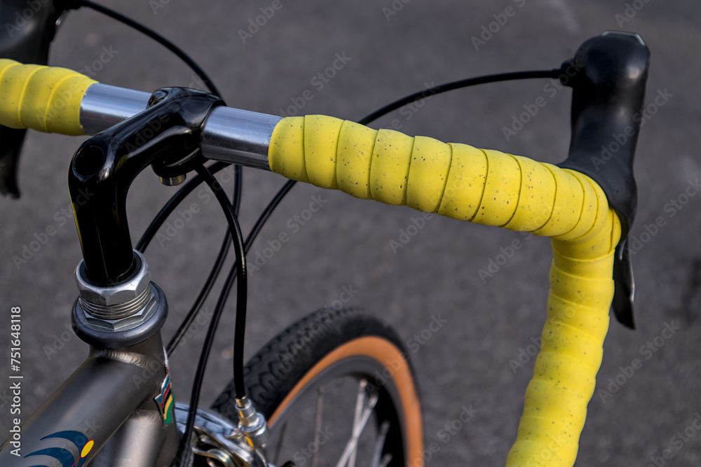 bike handlebar detail with bright yellow bar tape (bicycle cockpit
