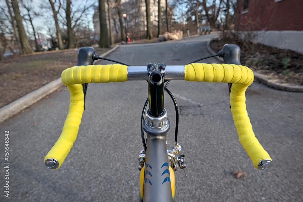bike handlebar detail with bright yellow bar tape (bicycle cockpit