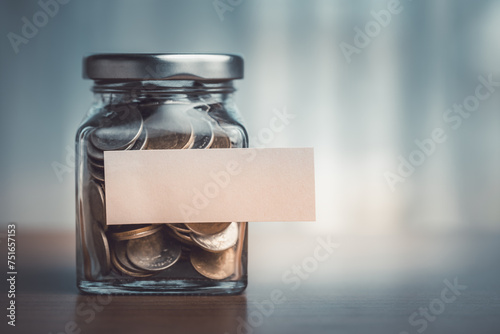 Coins in a glass jar with b...
