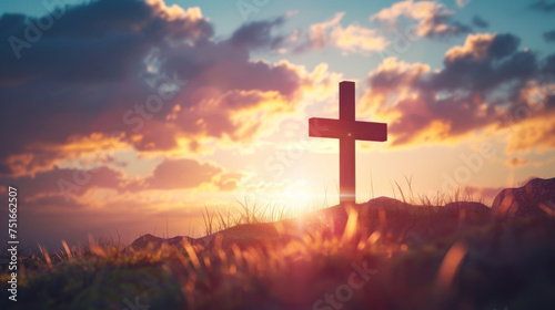 Silhouette of a wooden cross on a hill at sunset