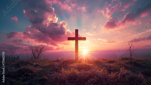 Wooden cross on mountaintop at sunset with radiant beams
