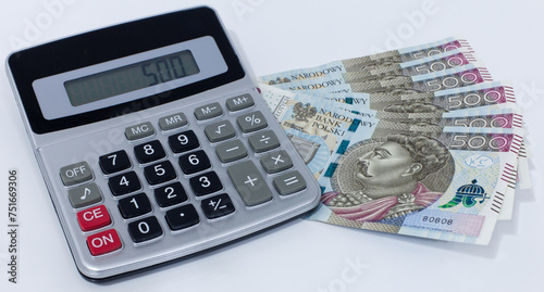 Polish banknotes with a calculator on a white background photo