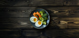 eggs, salmon and avocado in a plate on wooden background