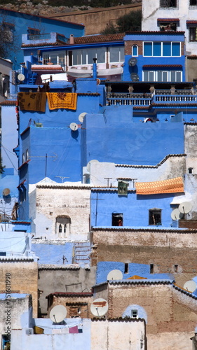 Blue and white buildings on a slope in the medina, in Chefchaouen, Morocco © Angela