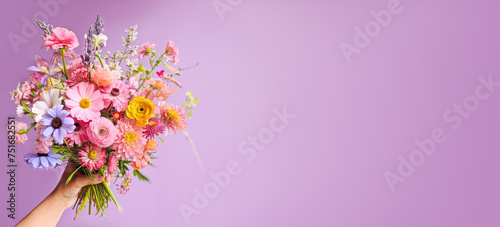 Colorful Mixed Bouquet Held in Hand Against Purple Background. Flower present. Summer garden bouquet. banner