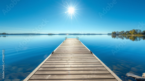 On a bright sunny day  a wooden pier or jetty stretches out into the water  offering a picturesque view.