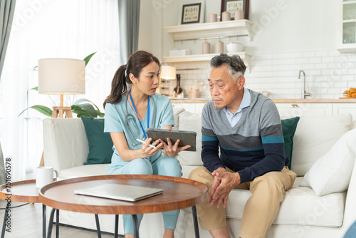Asian nurse showing health checkup report to grandfather and giving advice,nurse support senior older,medical assisted living visit senior patient at home.Home nursing and healthcare caregiver concept
