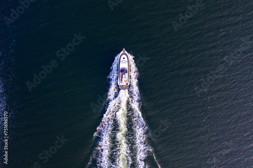 Yacht at sea full speed from above