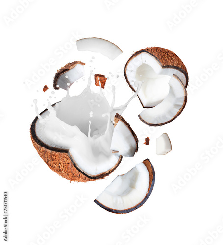 Crushed coconut in the air with milk splashes isolated on white background