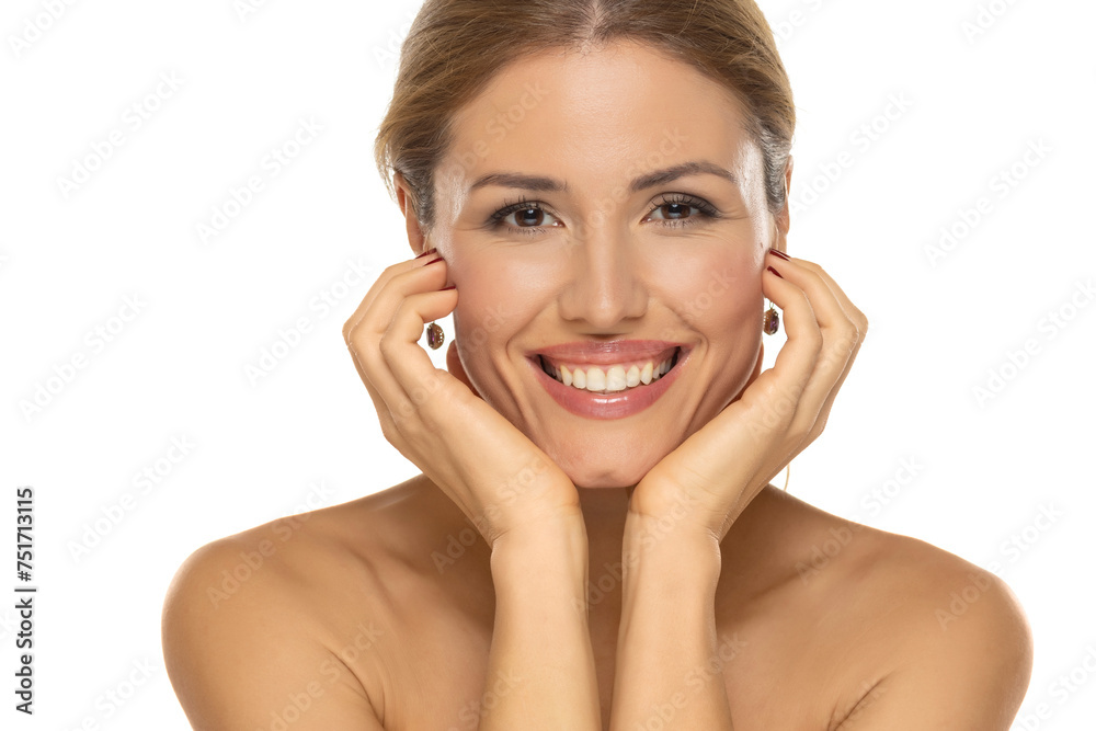 A portrait of a joyful woman with a beautiful smile and tasteful makeup,posing on white studio background, expressing happiness and confidence. A portrait of a joyful woman with a beautiful smile and tasteful makeup,posing on white studio background, expressing happiness and confidence.