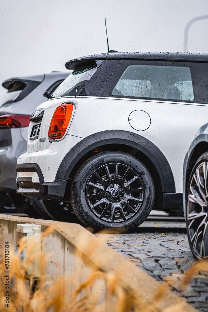 Detail of rear wheel with fender and light of a small stylish white ...