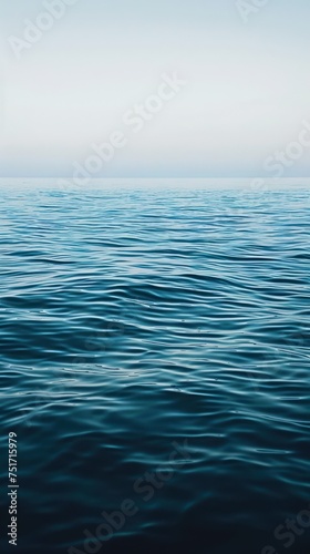Blue ocean water background. View of sea water and sky © Christiankhs