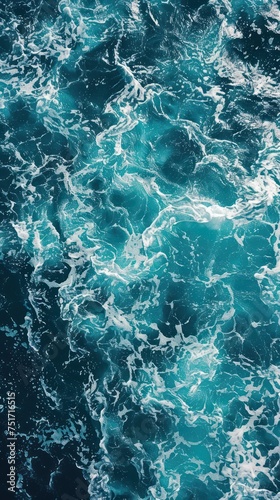 Blue sea water background. Top view of ocean surface with waves.