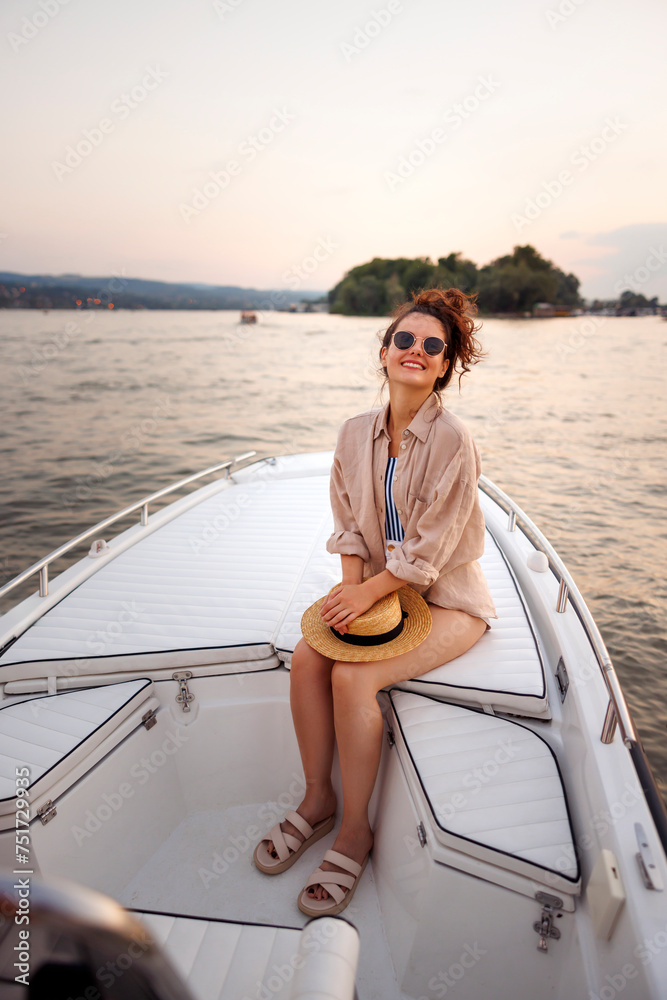 Woman sailing on a boat while on summer vacation