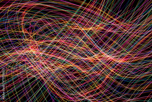 Sinusoidal wave chaos texture. Neon lights background. Motion lines texture. Colorful neon. Long exposure moving light pattern. Abstract night life background. Glowing lines design.
