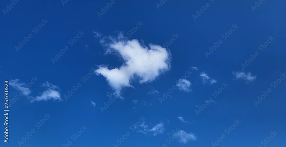 A blue sky and a white cloud that looks like a small fish A blue sky and a white cloud that looks like a small fish
